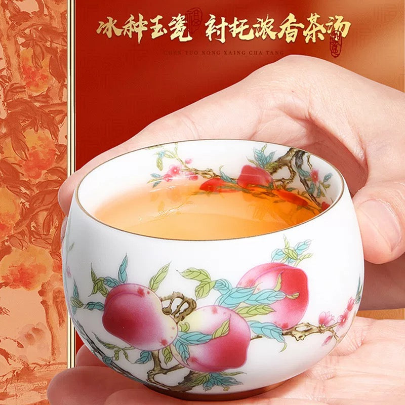 Peach Longevity Icy Jade Porcelain Tea Cup | Lucky Chinese Tea Bowl— Elegant icy jade porcelain tea cup with nine peaches pattern, enhancing tea aroma, symbol of longevity and good fortune for gifting.